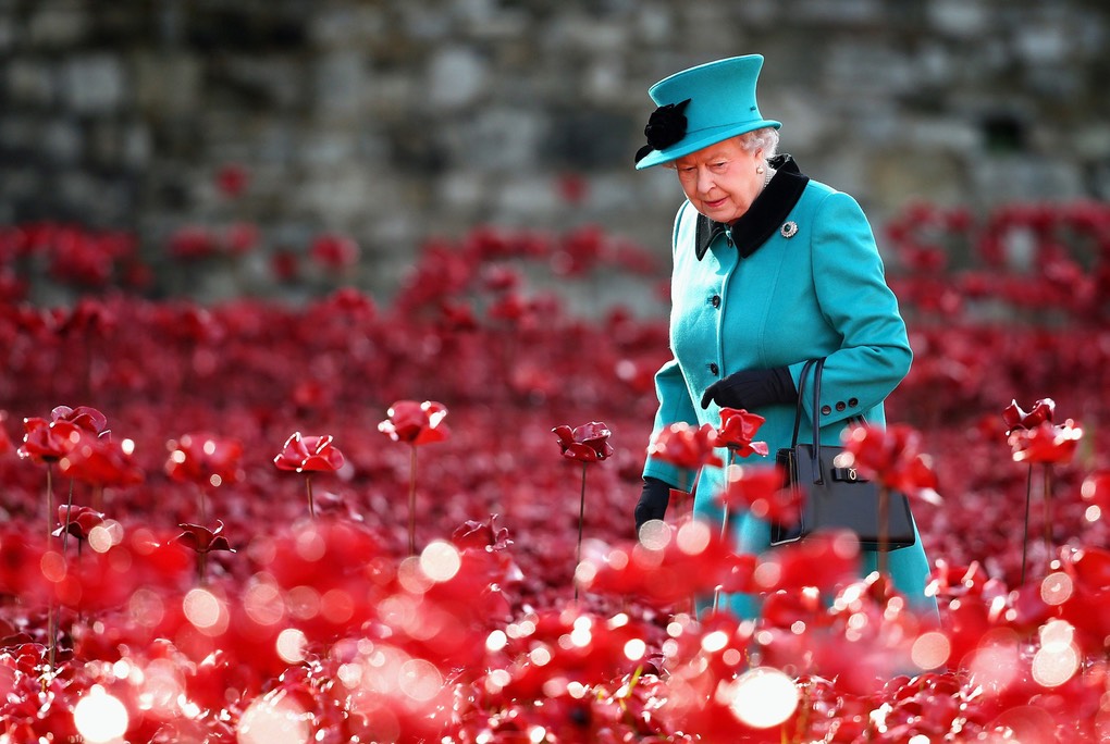 Pic 6. Queen Loitering- Britain's Queen Elizabeth II visits the Tower of London's 'Blood Swept Lands and Seas of Red' poppy installation in central London on October 16, 2014